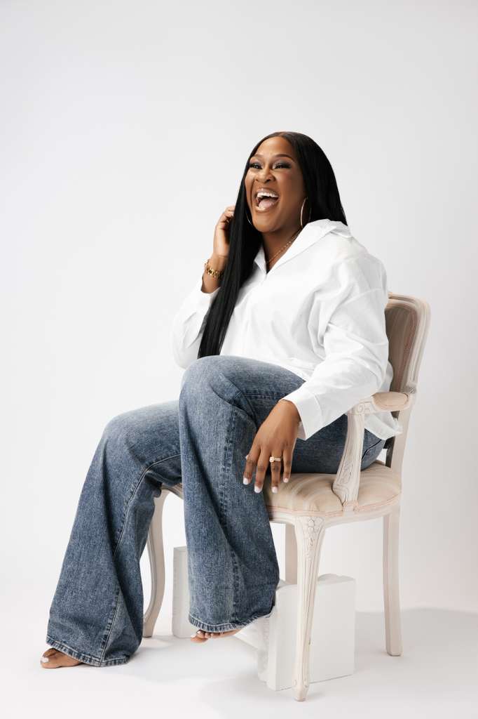 Tomilade Adebari smiling while seated