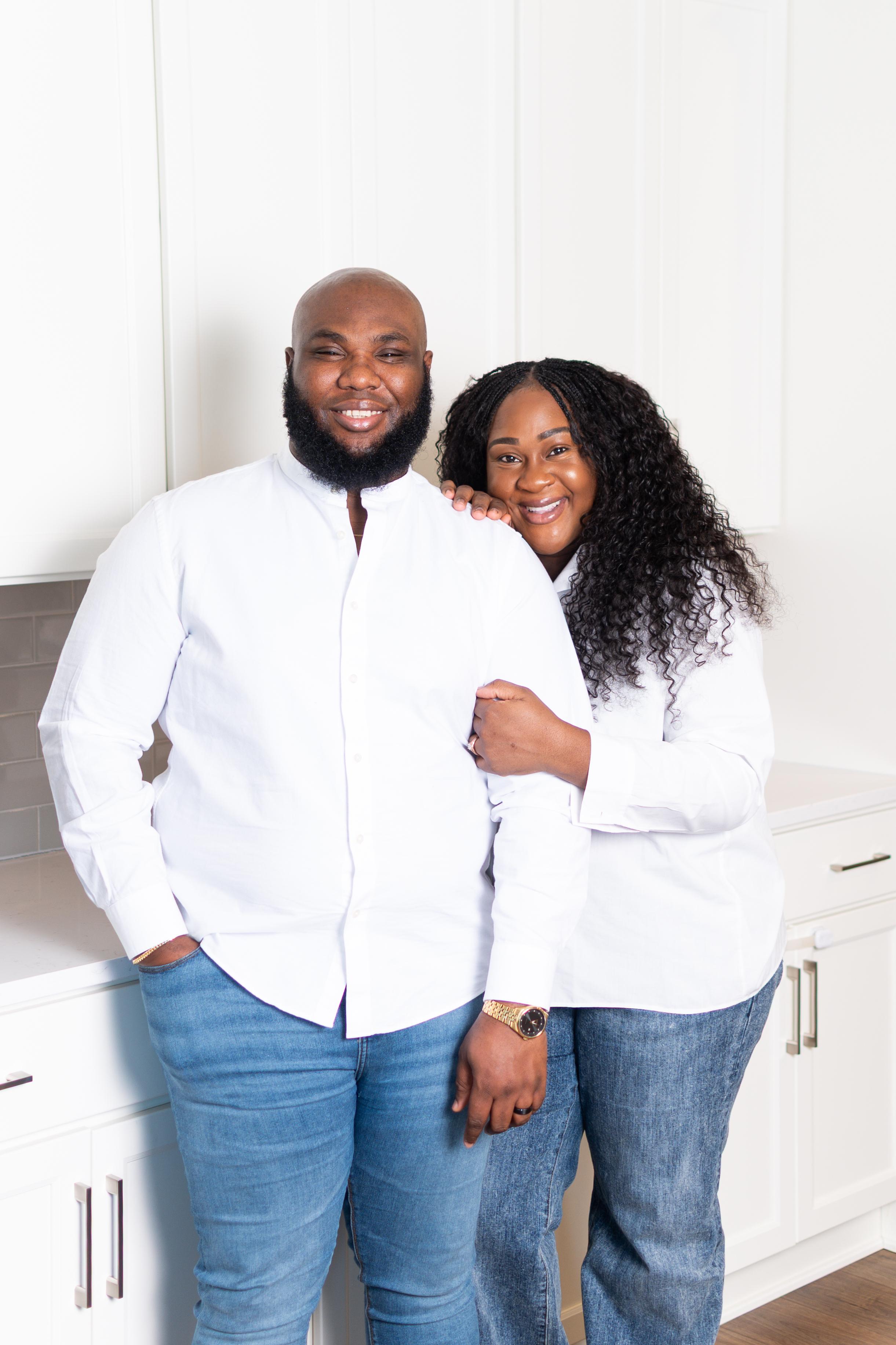Tomilade Adebari smiling while seated on a couch